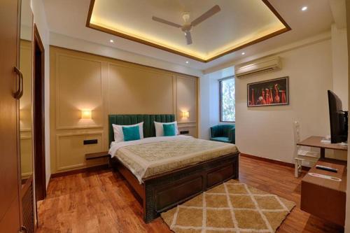 a bedroom with a bed with a ceiling fan at Gulmohar Mansion - A Boutique Stay in Jaipur