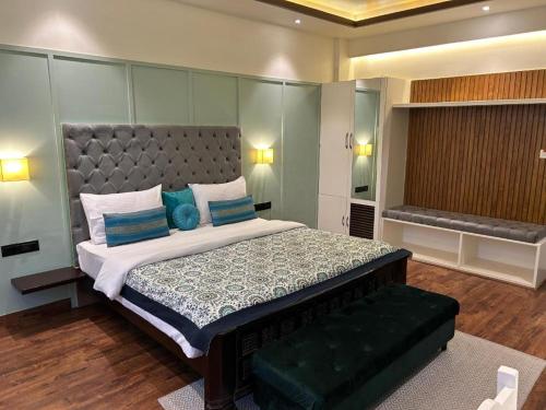 a bedroom with a large bed with blue pillows at Gulmohar Mansion - A Boutique Stay in Jaipur