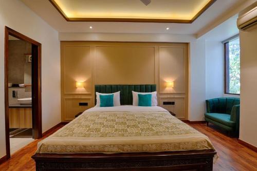 a bedroom with a large bed with blue pillows at Gulmohar Mansion - A Boutique Stay in Jaipur