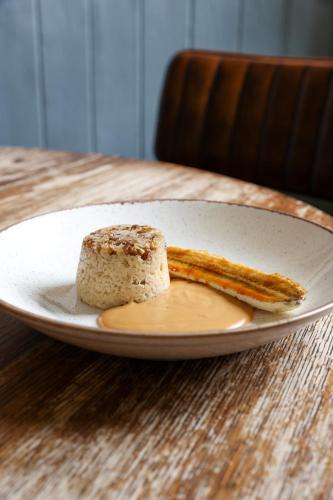 a plate with a piece of bread on a table at The Swan at Forest Row in Forest Row