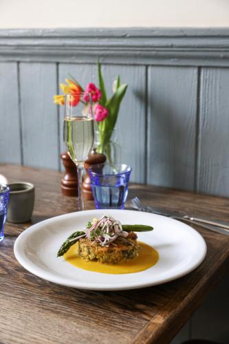 a plate of food sitting on a wooden table at The Swan at Forest Row in Forest Row