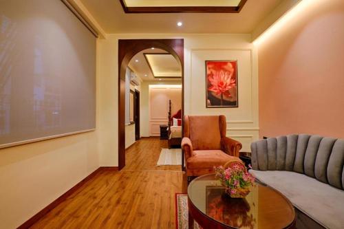 a living room with a couch and a table at Gulmohar Mansion - A Boutique Stay in Jaipur