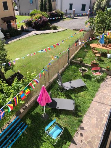 a yard with a fence with flags and a pool at La Primula Vicinanza 5 Terre in Riccò del Golfo di Spezia