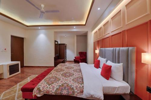 a bedroom with a large bed with red pillows at Gulmohar Mansion - A Boutique Stay in Jaipur