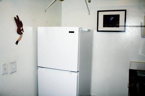 a white refrigerator in a kitchen with a picture on the wall at Quiet in Clarkdale in Clarkdale