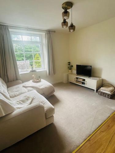 a living room with a bed and a tv at Croft Courtyard, Ambleside in Ambleside