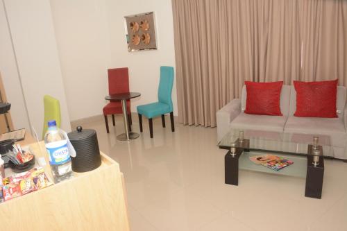 a living room with a couch and some chairs at Radisson Diamond Barranquilla in Barranquilla