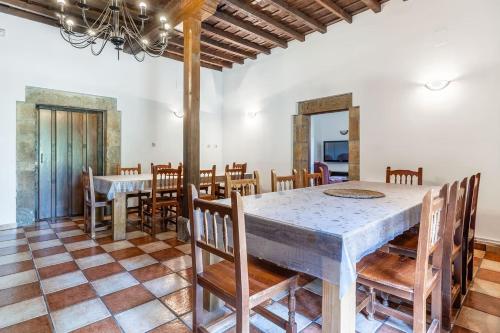 a dining room with a table and chairs at La Torre de Perrozo in Cabezón de Liébana