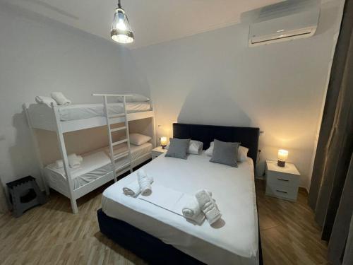 a bedroom with a bed and a bunk bed at Vanesa Rooms in Sarandë