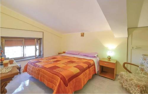 a bedroom with a bed and a chair in it at Charming Villa in Monreale with Private Pool in Pioppo