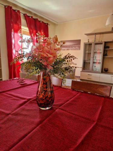 a vase filled with flowers sitting on a table at B&B da Giovy in Marsala