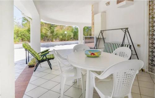 a white dining room with a white table and chairs at Charming Villa in Monreale with Private Pool in Pioppo