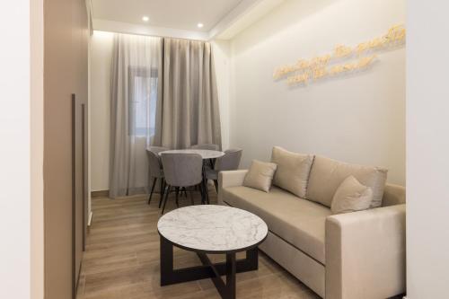 a living room with a couch and a table at Socrates Fully Equipped Apartments with Unique Design in Athens
