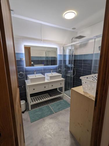 une salle de bain avec deux lavabos et un miroir dans l'établissement La maison des coteaux - Gîte avec vue d'exception, à Fronsac