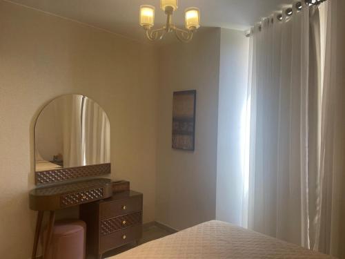a bedroom with a dressing table and a mirror at Monte galala chalet in Ain Sokhna
