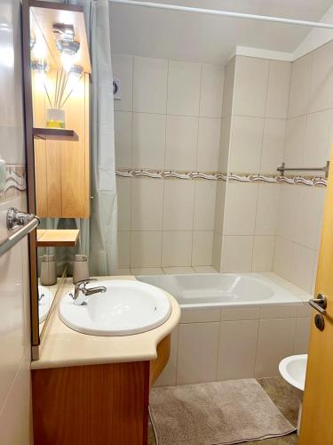 a bathroom with a sink and a bath tub at Villa Abreu in Ponta do Sol