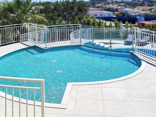a large swimming pool with blue water at Vistas Mar Villas D by Stay ici in Albufeira