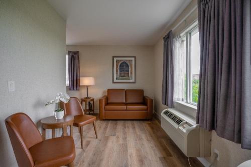 a hospital waiting room with a chair and a window at Monte Carlo Inn Oakville Suites in Oakville