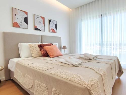 a bedroom with a large bed with a large window at Vistas Mar Villas D by Stay ici in Albufeira