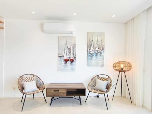 a living room with two chairs and a coffee table at Vistas Mar Villas D by Stay ici in Albufeira