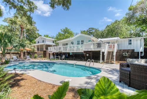 a home with a swimming pool and a house at 116 E Hudson - Heaven's Folly - Private Pool - Central Location in Folly Beach