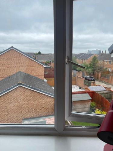 a window with a view of a building at Wavertree Accomodation in Liverpool