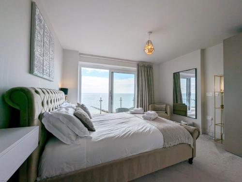 a bedroom with a large bed and a large window at West Lodge, Bognor Regis in Bognor Regis