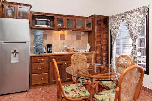 a kitchen with a table and chairs and a refrigerator at X'tan Ha- The Waterfront in San Pedro