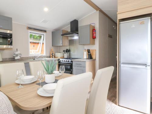 a kitchen and dining room with a table and chairs at Elton's Escape in Windermere