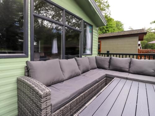 a large couch sitting on the side of a house at Elton's Escape in Windermere