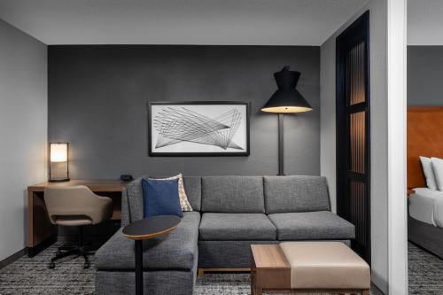 a living room with a couch and a desk at Hyatt Place Columbus/Dublin in Dublin