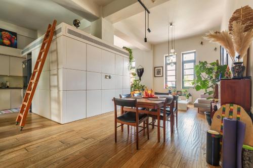 a kitchen and living room with a table and chairs at Thisseion Lofts George in Athens