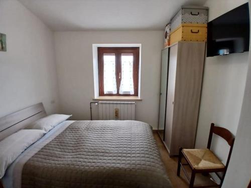 une chambre avec un grand lit et une fenêtre dans l'établissement Rifugio San Vicino, à San Severino Marche