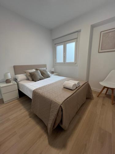 En eller flere senge i et værelse på Premium Apartments Almeria Centro