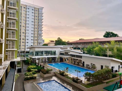 an aerial view of a building with a swimming pool at Mesaverte Residences Cozy Studio Unit in Cagayan de Oro