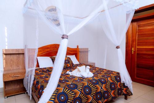 Postel nebo postele na pokoji v ubytování Future4Kids Kinigi Guest House By Isange paradise resort