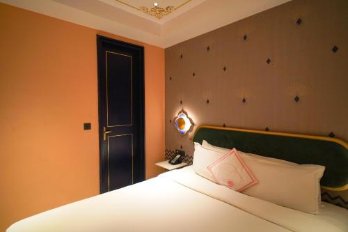 a bedroom with a bed and a door and a bed sidx sidx sidx at Bur'Dera - a Boutique Luxury Hotel in Jaipur