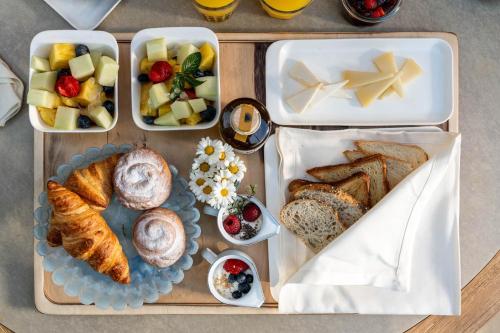 a tray filled with different types of bread and desserts at Hotel Ritual de Terra & SPA Moraira in Moraira