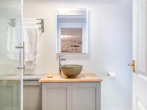 a bathroom with a sink with a bowl on a counter at The Cider Press at Deep Filling Farm, woodland luxury in Gloucestershire