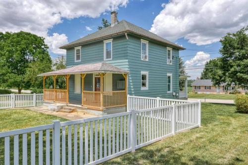 a blue house with a white fence in front of it at The Farm House in Dillsburg