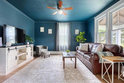 a living room with a couch and a ceiling fan at The Farm House in Dillsburg