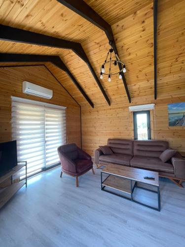 a living room with a couch and a coffee table at 101 Gün Kiralık Havuzlu Lake House kayacık in Dalaman
