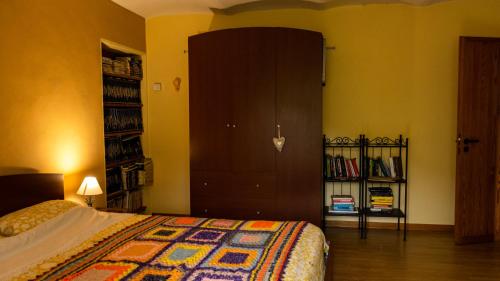 a bedroom with a bed and a book shelf at B&B La finestra sul bosco in Serralunga di Crea