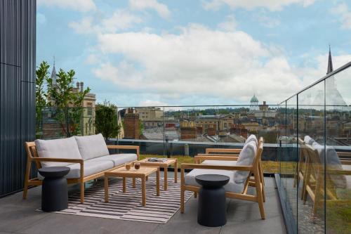 a balcony with furniture and a view of a city at The Store in Oxford