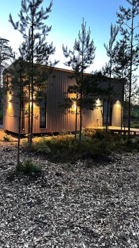 a small house with trees in front of it at ForRest Glamp Saulkrasti in Saulkrasti