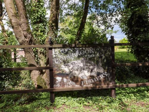 a sign with a picture of a tiger on a fence at Ambleside in Cullompton