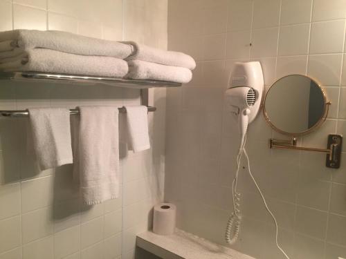 a bathroom with a blow dryer and towels at Travels Inn Victoria County in Boularderie East