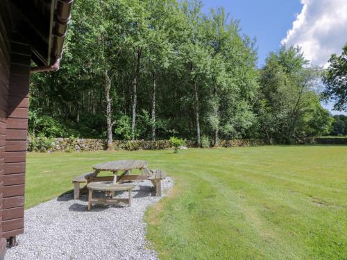 a picnic table in a park with a field at Moyle Lodge in Dalbeattie