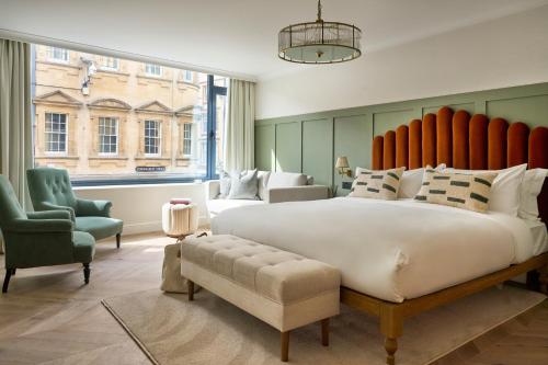 a large bedroom with a large bed and two chairs at The Store in Oxford