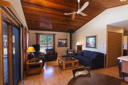 a living room with a blue couch and a table at Overlander Mountain Lodge in Jasper